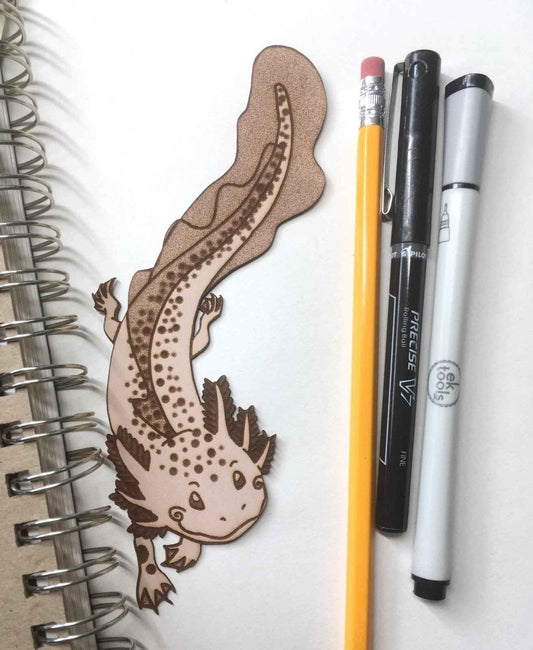 A leather bookmark shaped like an axolotl salamander.