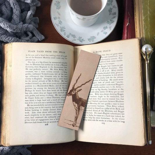 A leather bookmark engraved with the art of a blackbuck antelope.