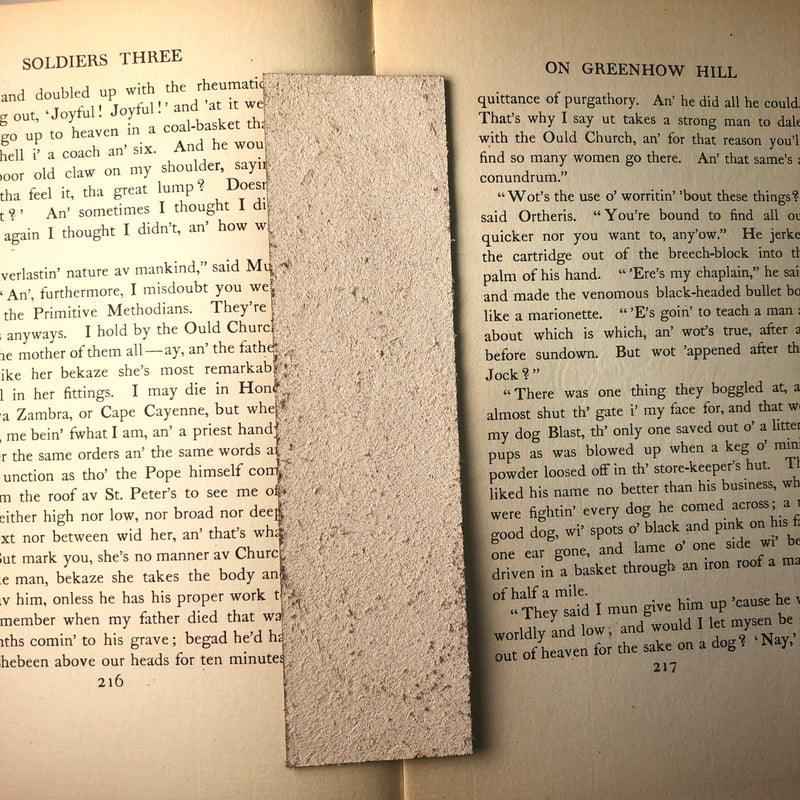 The backs of the leather bookmarks are unfinished and you can see the leather grain.