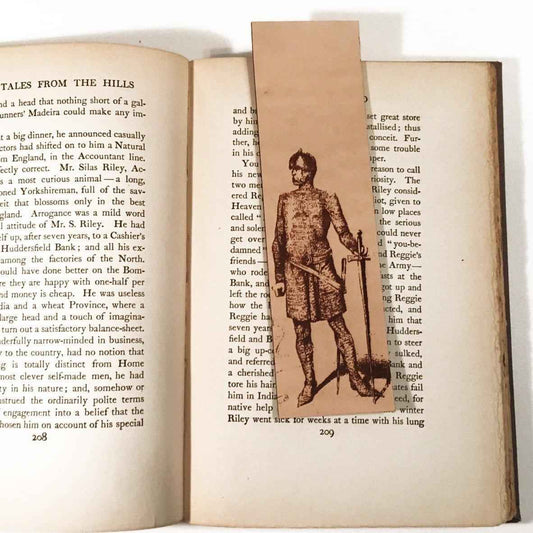 A leather bookmark with the antique art of a knight wearing chain mail on it.