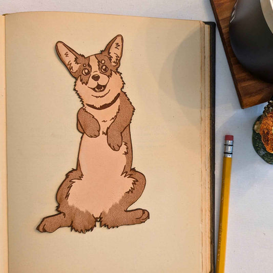 A cute leather bookmark of a corgi that is also shaped like a corgi.