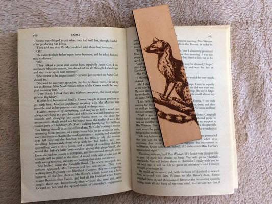 Historical genet illustration engraved on a leather bookmark.