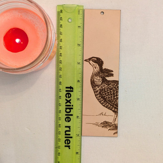 The leather greater prairie chicken bookmark next to a ruler for scale. Greater Prairie Chicken Bird Bookmark - Leather Bookmarks Raven King Crafts