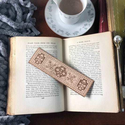 A leather bookmark engraved with the antique floral art.