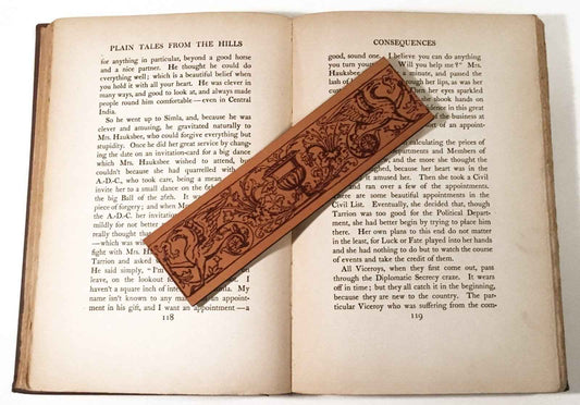 A leather bookmark engraved with the antique art of a hippogriff, the mythical beast.
