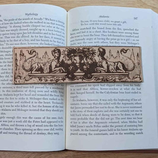 A leather bookmark engraved with the antique art of the sphinx mythical beasts.