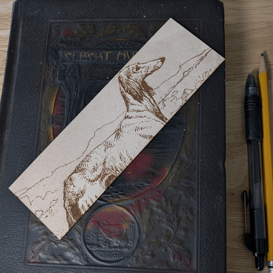 A rectangular leather bookmark with the historical art of an Afghan Greyhound dog engraved on it. Leather Afghan Greyhound Bookmark Bookmarks Raven King Crafts