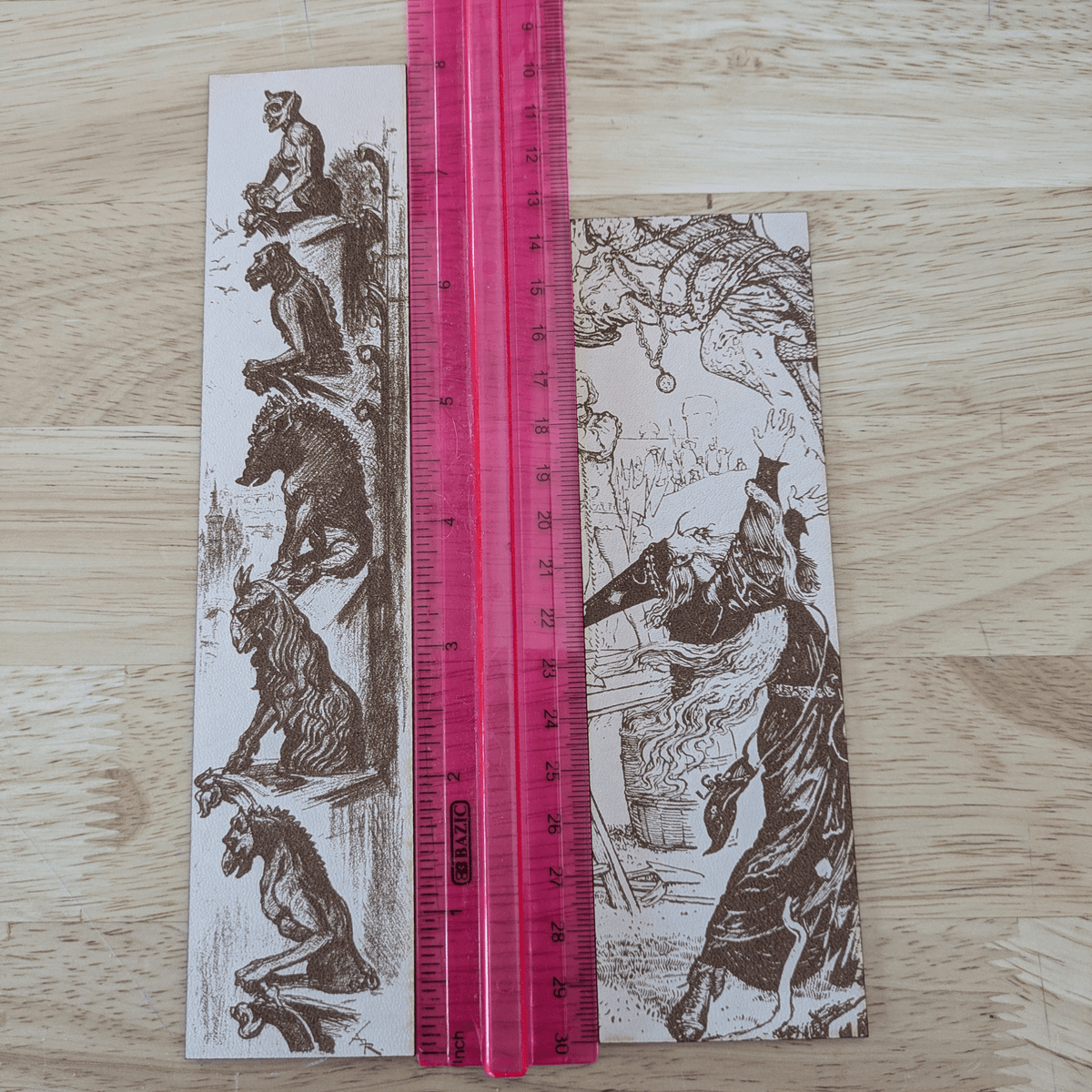 The leather wizard bookmark and gargoyle bookmark next to a ruler for scale. Leather Engraved Gargoyles Bookmark