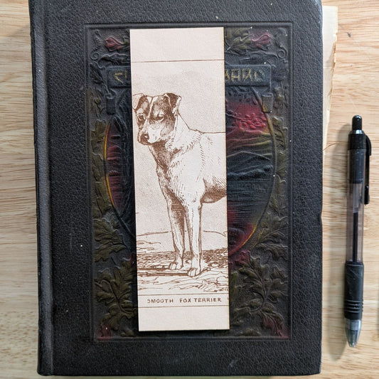 A rectangular leather bookmark with the historical art of a smooth fox terrier dog engraved on it. Leather Fox Terrier Dog Bookmarks Bookmarks Raven King Crafts
