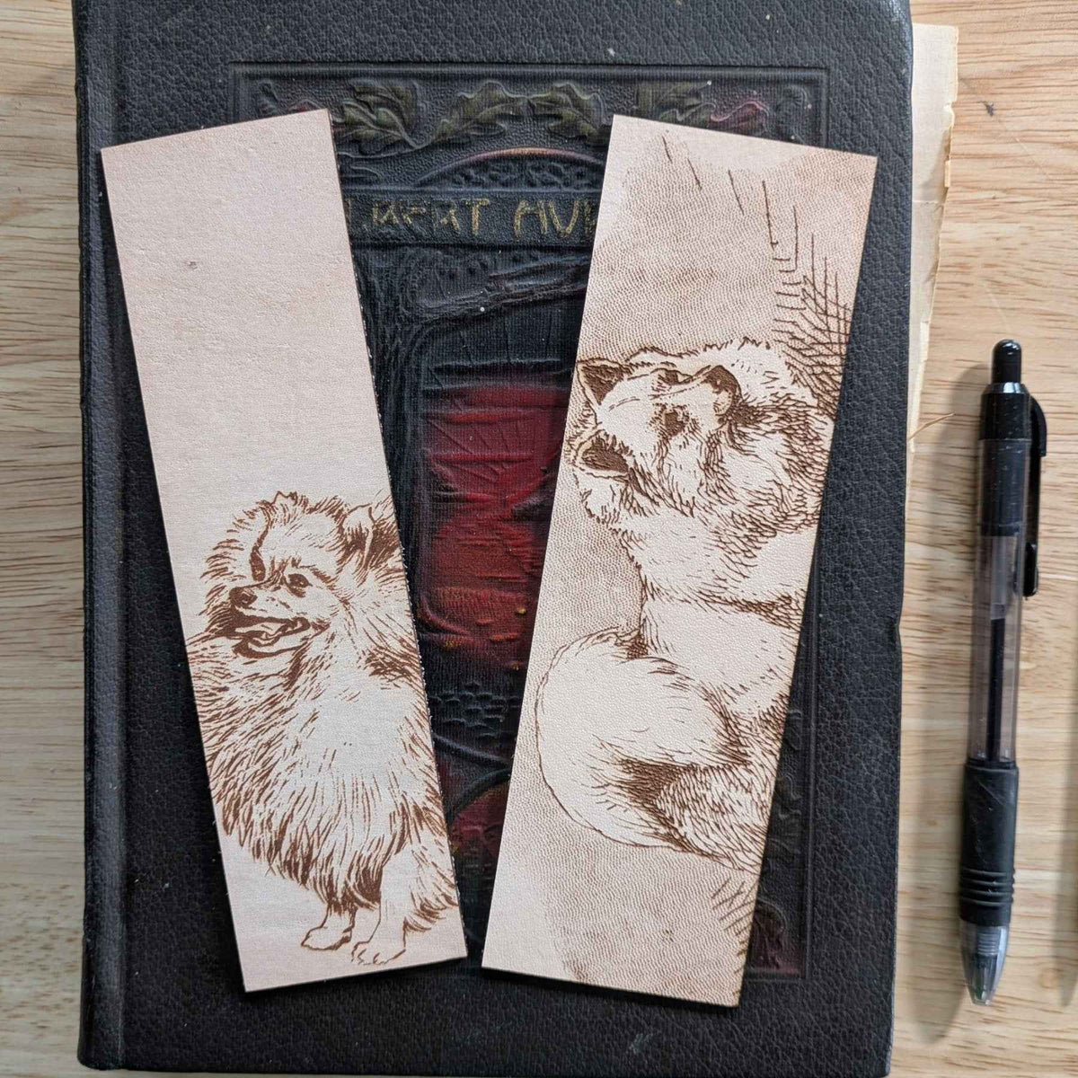 These leather bookmarks are engraved with the art of a pomeranian dog on it. Leather Pomeranian Bookmark Bookmarks Raven King Crafts