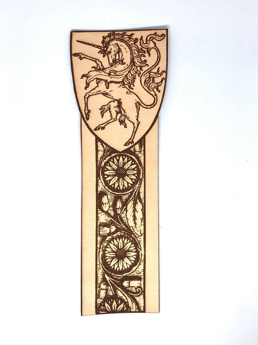 A leather bookmark engraved with the antique art of a unicorn.