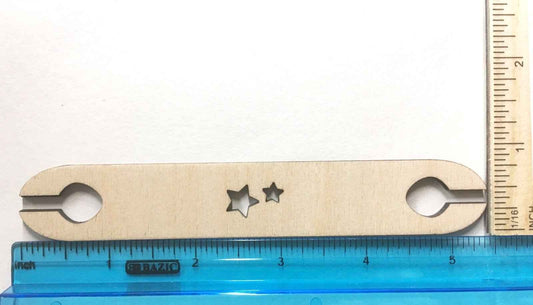 Our wooden loom shuttle next to a rulter to show scale.