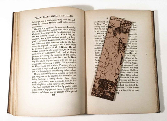 A leather bookmark with the antique art of a Princess Leaning Out The Tower on it.