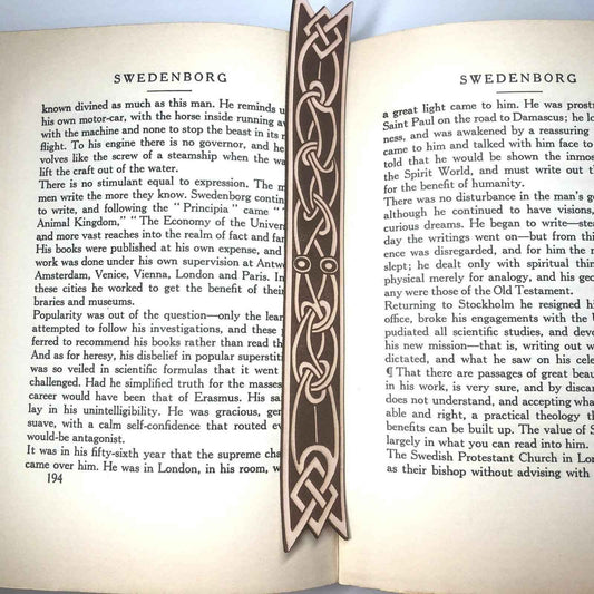A leather bookmark with the antique art of Celtic ribbon on it.