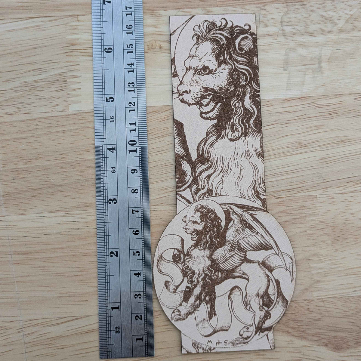 A photograph of a genuine leather bookmark engraved with the historical art of the lion of Saint Mark.