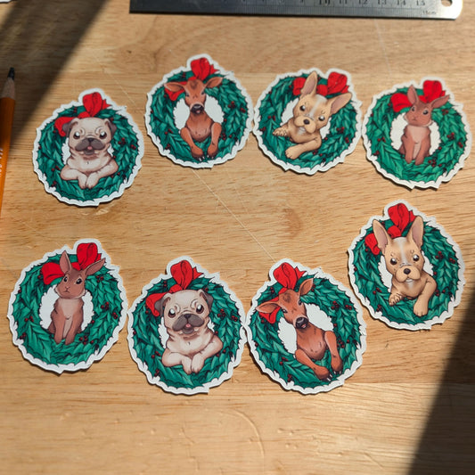 Christmas themed pack of stickers, the photo shows the 8 stickers. The stickers are: 2x rabbit in a wreath, 2x pug in a wreath, 2x calf (baby cow) in a wreath and 2x french bulldog in a wreath. 