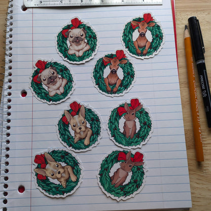 Christmas themed pack of stickers, the photo shows the 8 stickers. The stickers are: 2x rabbit in a wreath, 2x pug in a wreath, 2x calf (baby cow) in a wreath and 2x french bulldog in a wreath. 