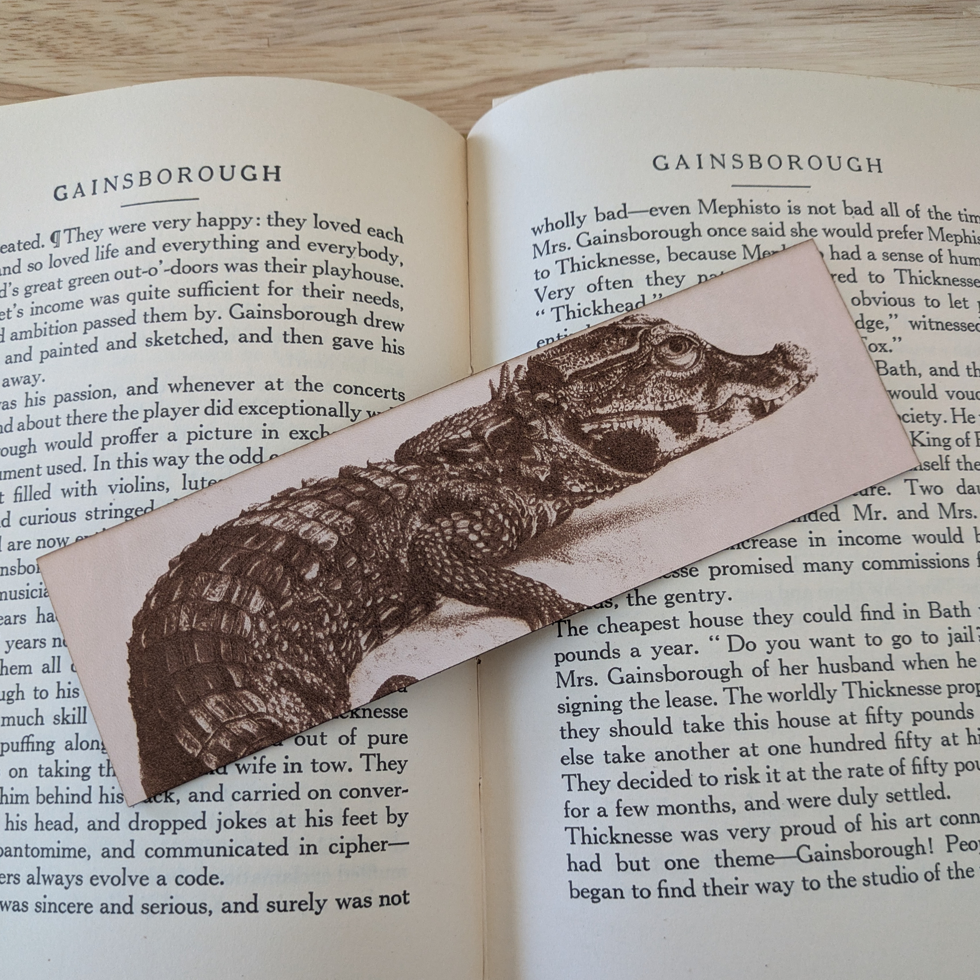 A leather bookmark engraved with the art of a West African Crocodile on it.