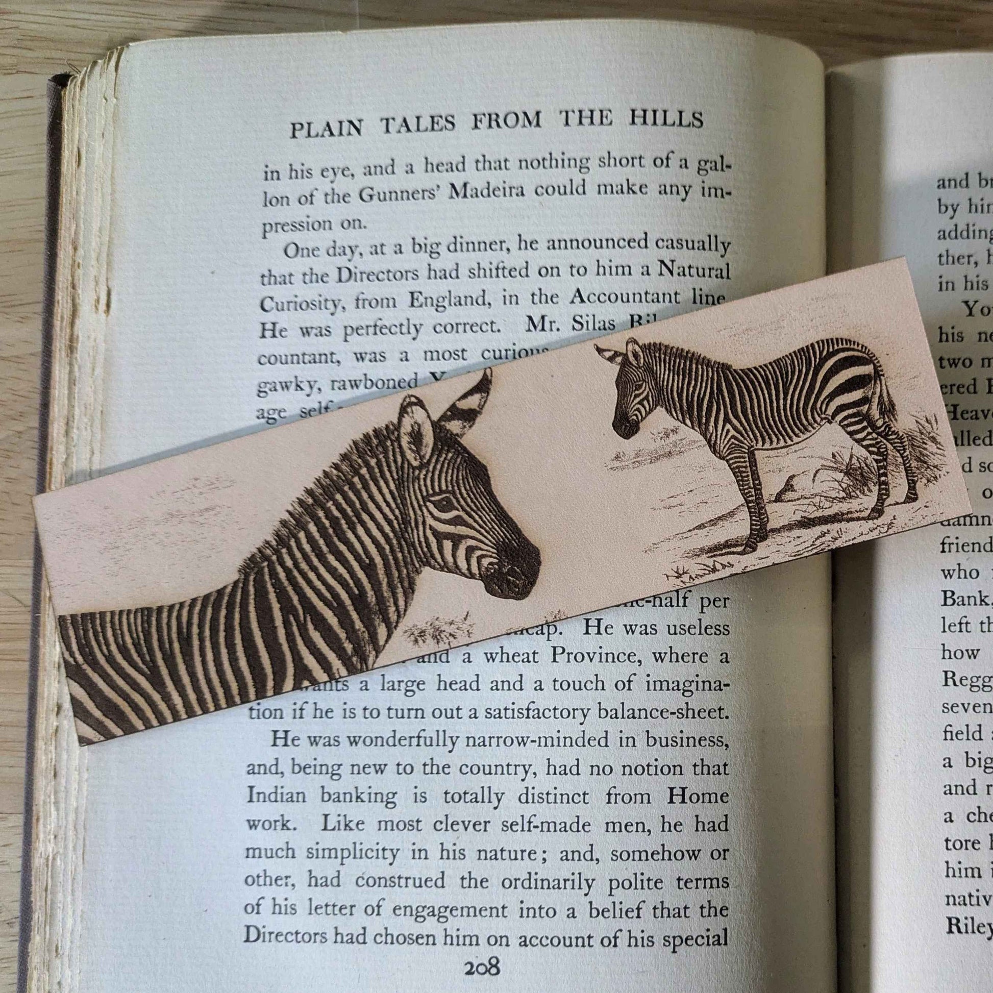 A leather bookmark engraved with the art of a mountain zebra on it.
