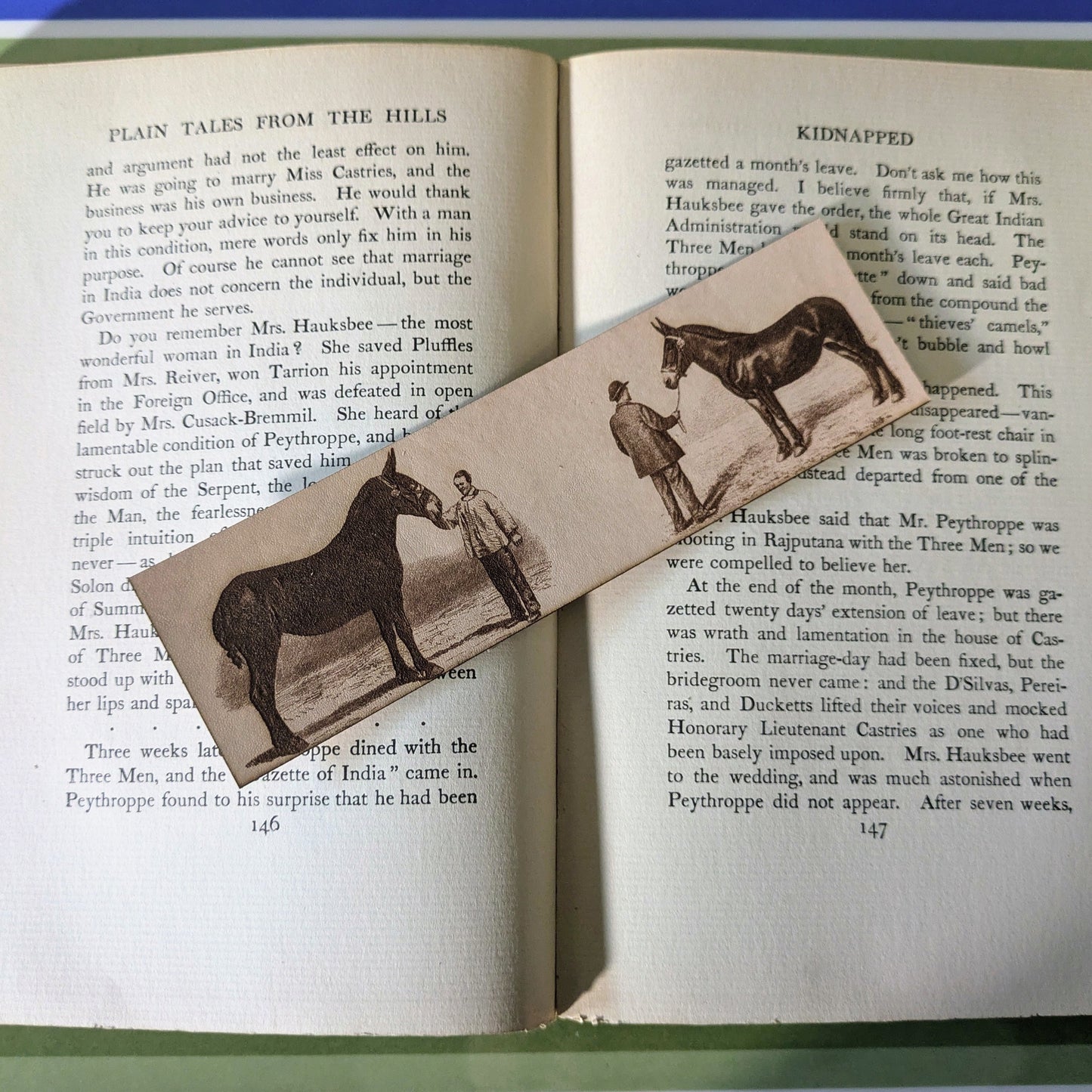 A leather bookmark with the art of mules engraved on it. 
