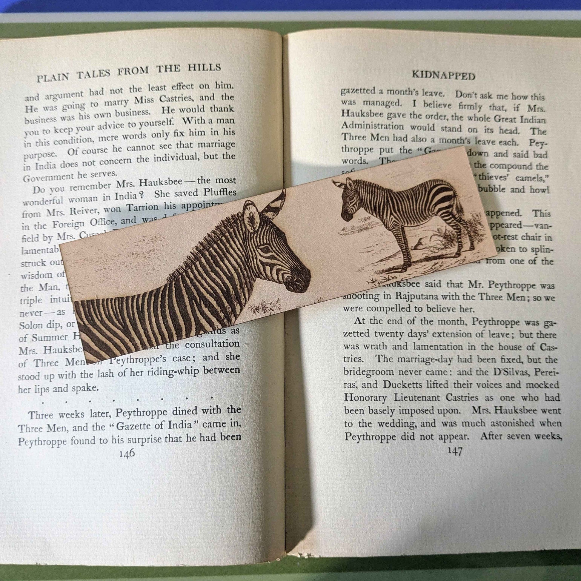 A leather bookmark engraved with the art of a mountain zebra on it.