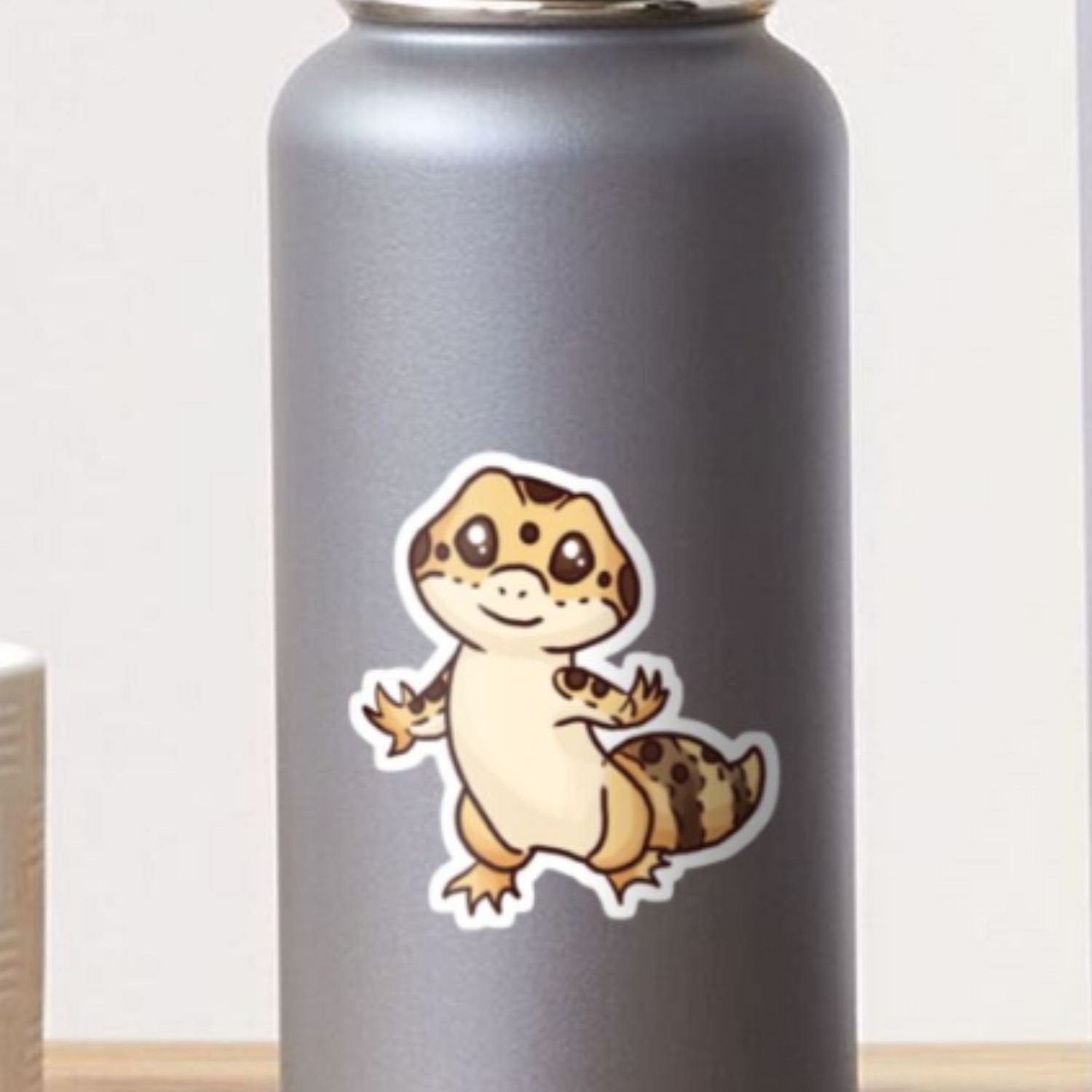 Photo of an adorable chibi gecko sticker on a water bottle. 