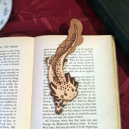 A leather bookmark shaped like an axolotl salamander. Adorable Axolotl Salamander Leather Bookmark Bookmarks Raven King Crafts