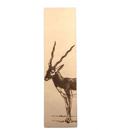 A photo of a leather rectangular bookmark with the art of a blackbuck antelope engraved on it.