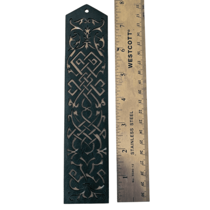 The blue leather cutout bookmark next to a ruler to show scale. Blue Cutout Leather Bookmark with Tassel Hole Bookmarks Raven King Crafts