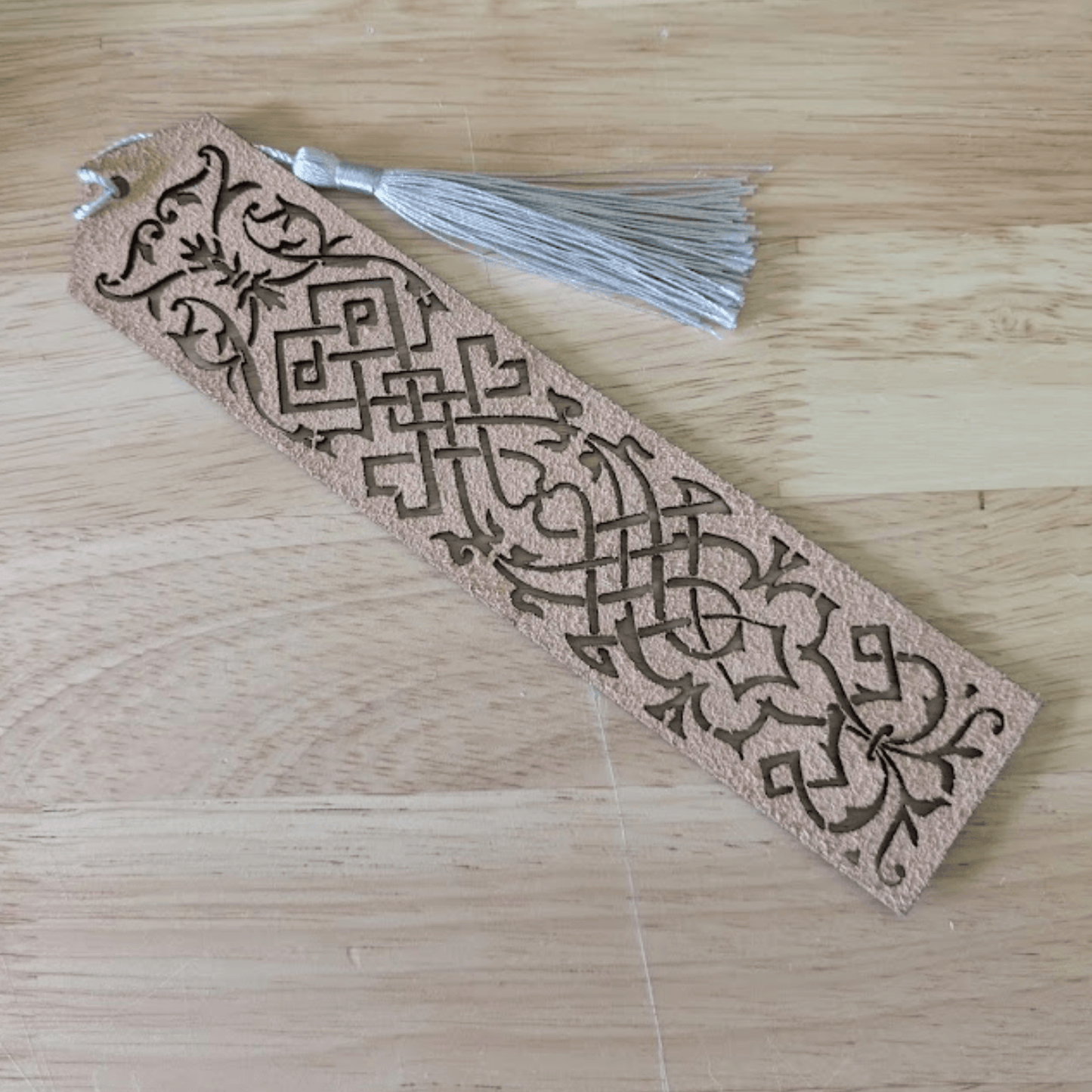 The back of the blue leather bookmark is unfinished. Blue Cutout Leather Bookmark with Tassel Hole Bookmarks Raven King Crafts