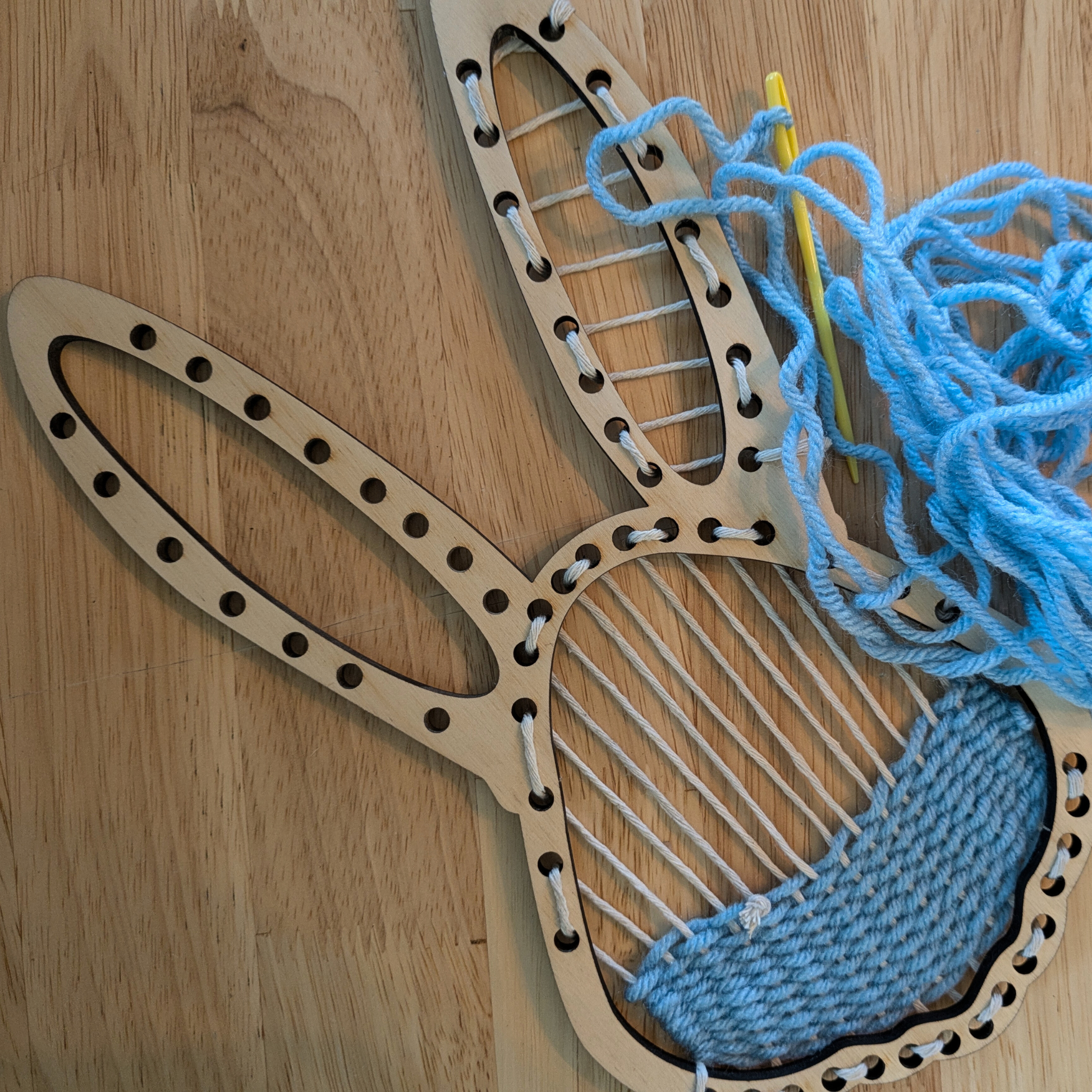 An example of the bunny loom with a weaving started.