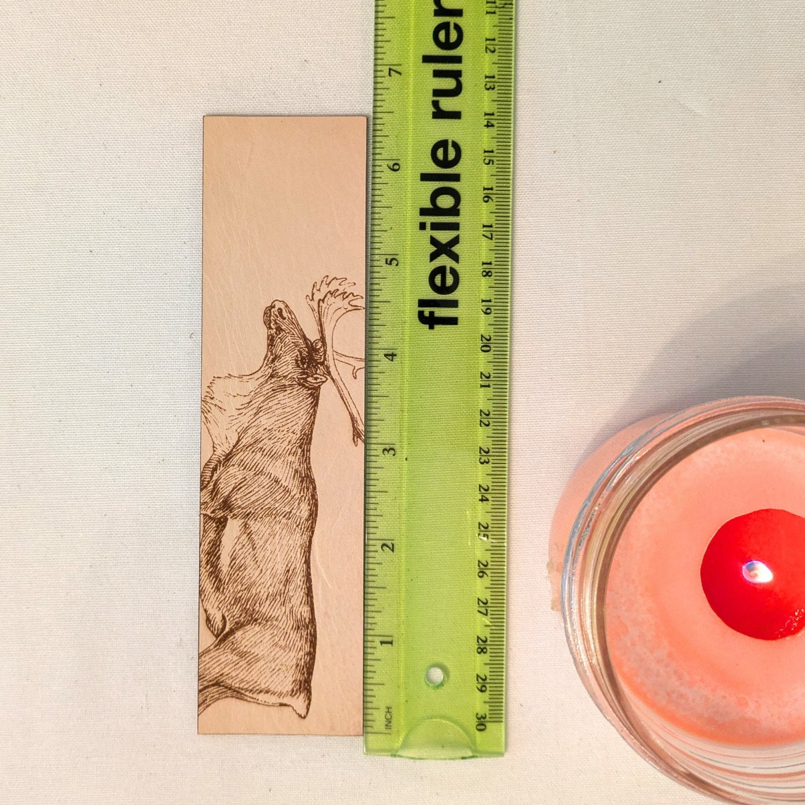 A photograph of caribou or reindeer leather bookmark next to a ruler for scale. Caribou (Reindeer) Bookmark - Leather Bookmarks Raven King Crafts