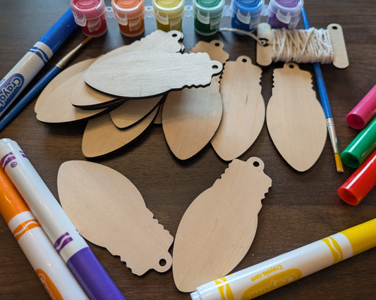 A photograph of our wooden lightbulb shaped ornament blanks. Next to them are some of the paint and marker options. Christmas Lightbulb Ornaments - 14 Pack Ornament Raven King Crafts