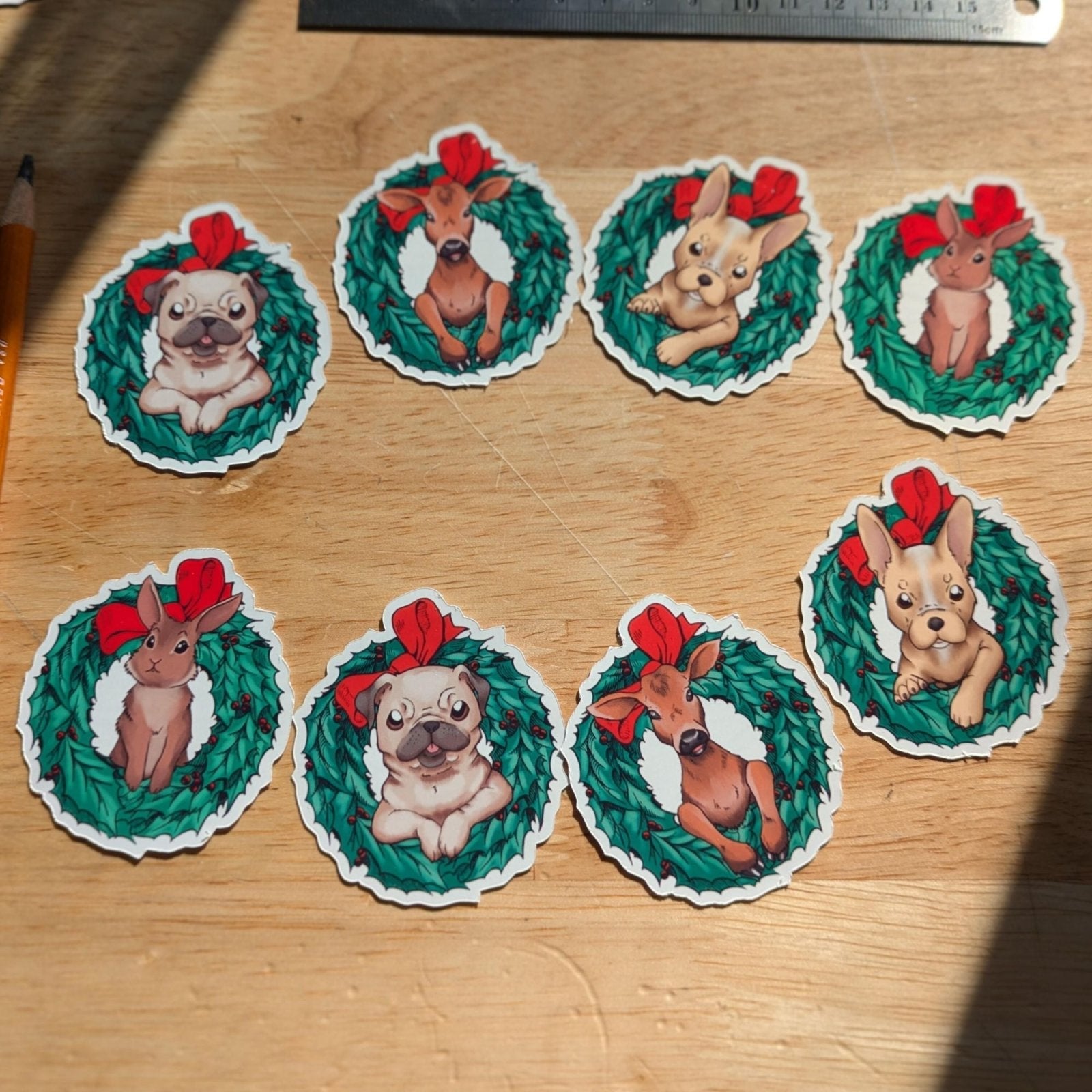 Christmas themed pack of stickers, the photo shows the 8 stickers. The stickers are: 2x rabbit in a wreath, 2x pug in a wreath, 2x calf (baby cow) in a wreath and 2x french bulldog in a wreath. Christmas Themed Sticker Pack stickers Raven King Crafts Christmas Themed Sticker Pack stickers Raven King Crafts