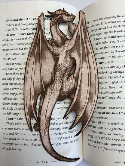 A full length photo of the leather dragon bookmark. The bookmark looks like a dragon climbing on the pages of a book. Climbing Dragon Bookmark Bookmarks Raven King Crafts