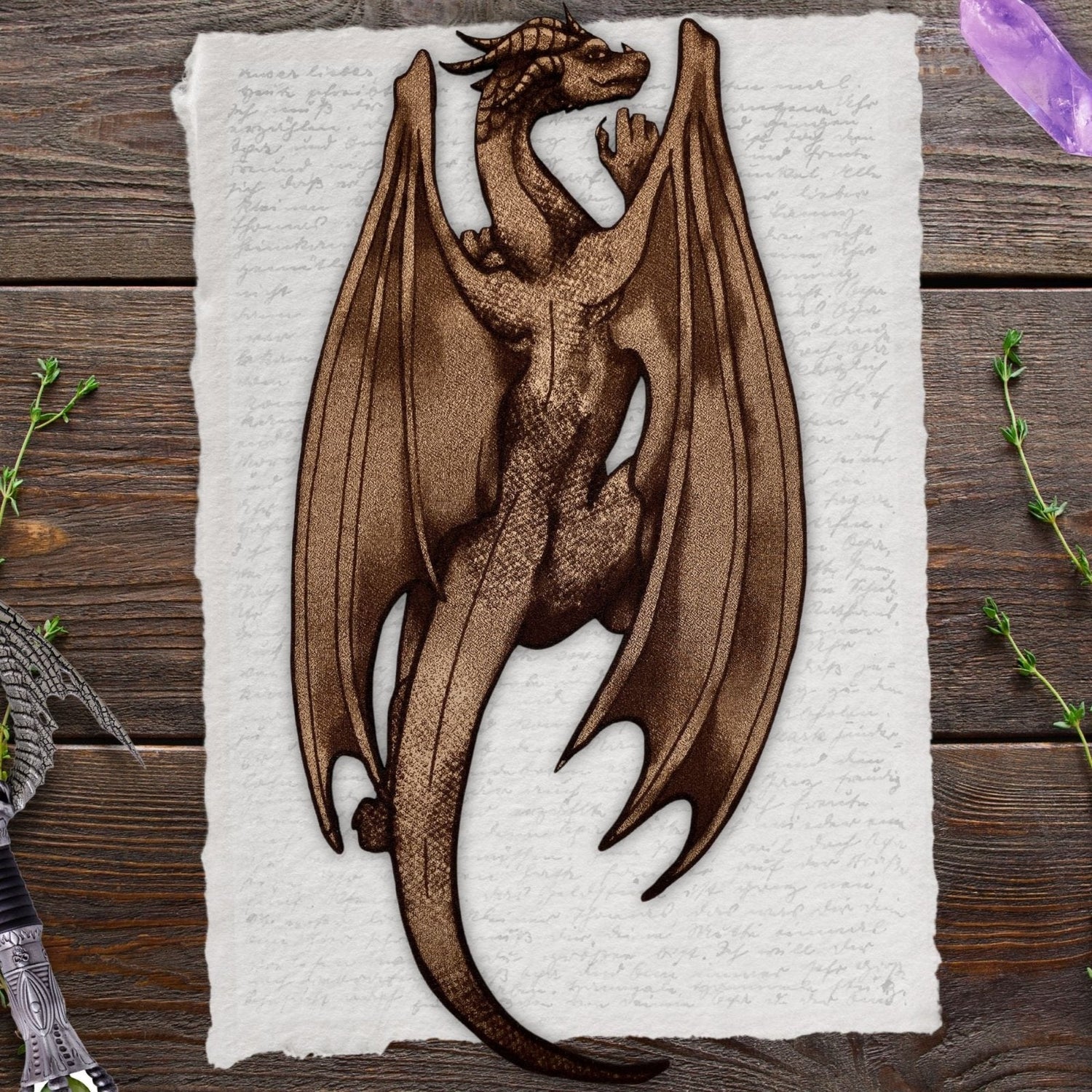 A leather dragon shaped bookmark resting on an old page. The dragon bookmark is made out of leather.