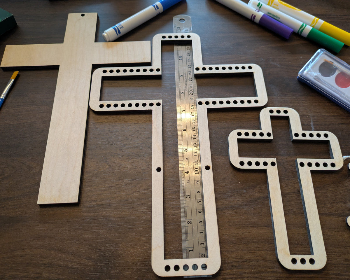 A photograph of the wooden cross shaped weaving loom next to the ruler. 