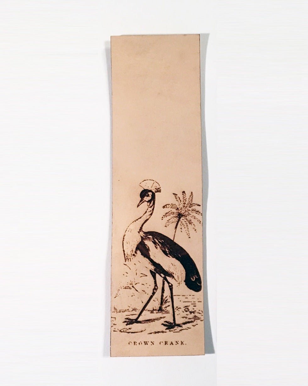 Leather bookmark with a crown crane on it.