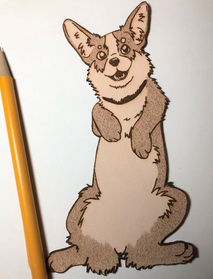 A corgi bookmark next to a pencil.