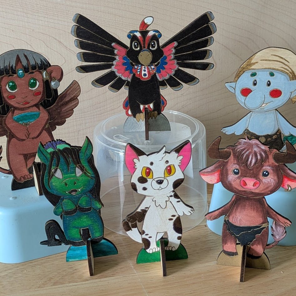 Chibi mythological creatures wooden standing figures colored. Left to right: Sphinx, Thunderbird, Troll, Kelpie, Nekomata and Minotaur DIY Myths, Legends and Monster Chibi Set: Coyote, Cthulhu, Da - jo - ji, Kelpie, Kitsune, Minotaur, Nekomata, Spinx, Thunderbird and Troll Art & Craft Kits Raven King Crafts DIY Myths, Legends and Monster Chibi Set: Coyote, Cthulhu, Da-jo-ji, Kelpie, Kitsune, Minotaur, Nekomata, Spinx, Thunderbird and Troll Art & Craft Kits Raven King Crafts