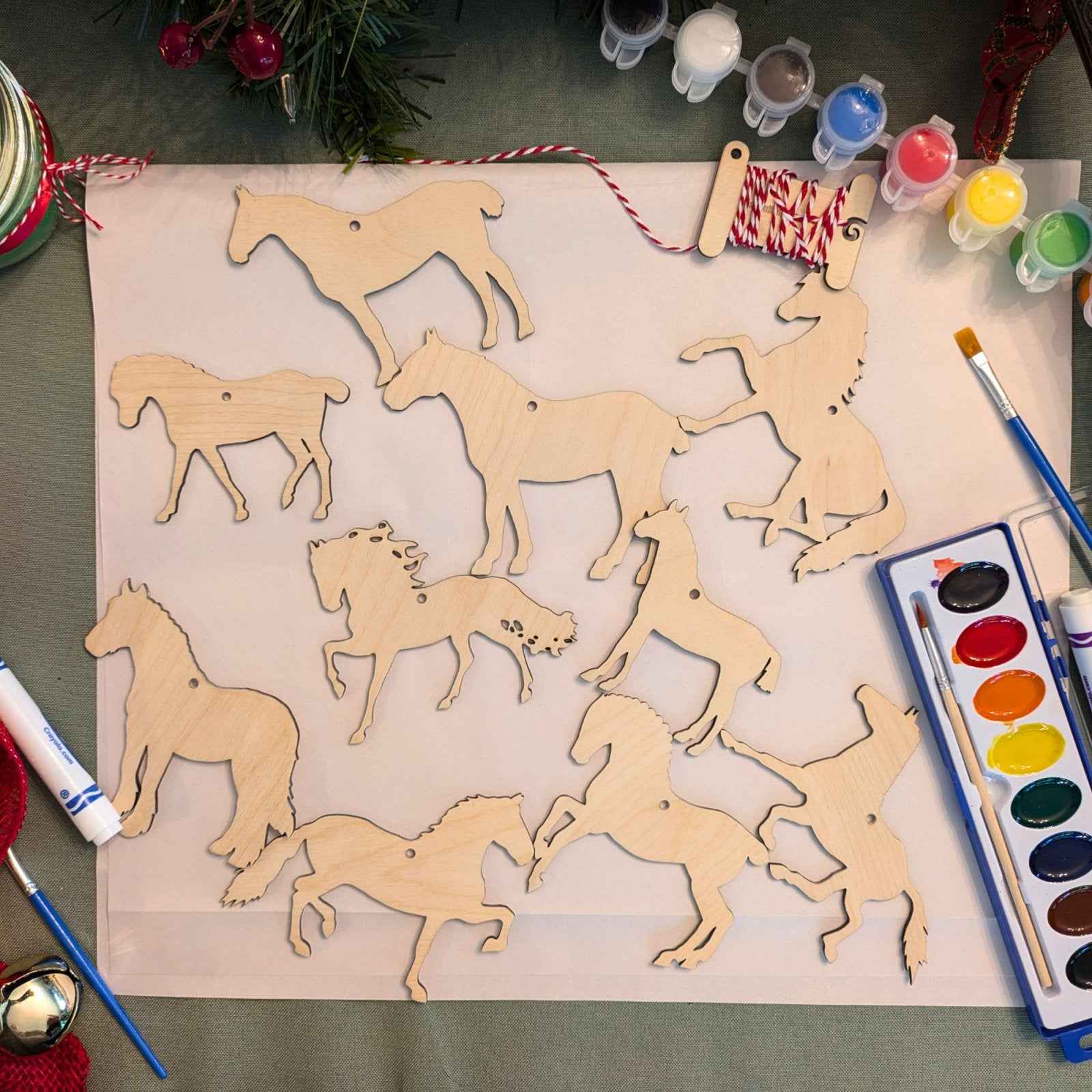 Set 1 of the horse ornament blank kit next to some Christmas decorations. DIY Wooden Horse Ornament Kit - 10 Unique Horse Shapes per Set - 20 total! Art & Crafting Materials Raven King Crafts