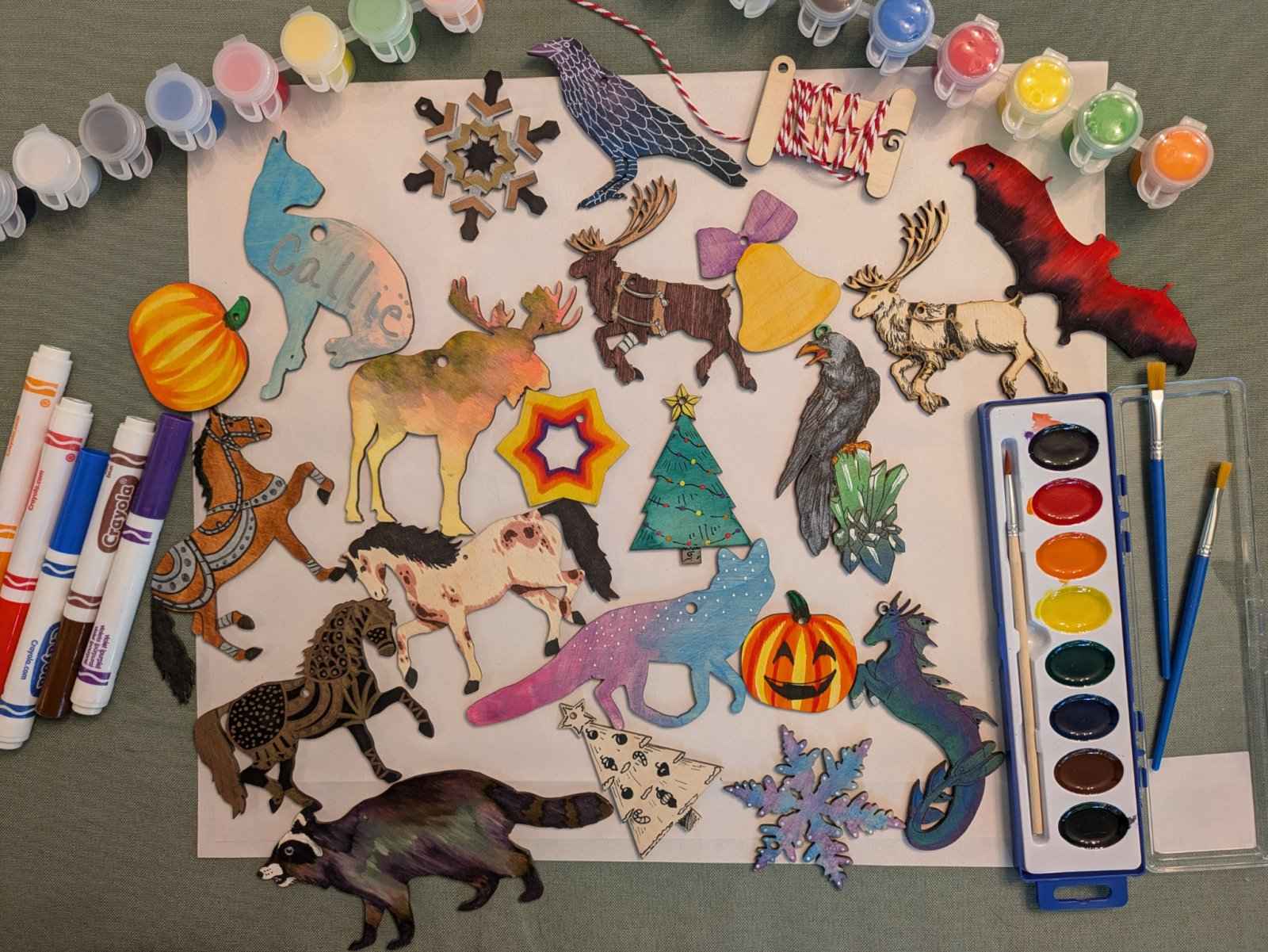 A photograph of different wooden ornaments we sell painted, colored and stained. DIY Wooden Horse Ornament Kit - 10 Unique Horse Shapes per Set - 20 total! Art & Crafting Materials Raven King Crafts