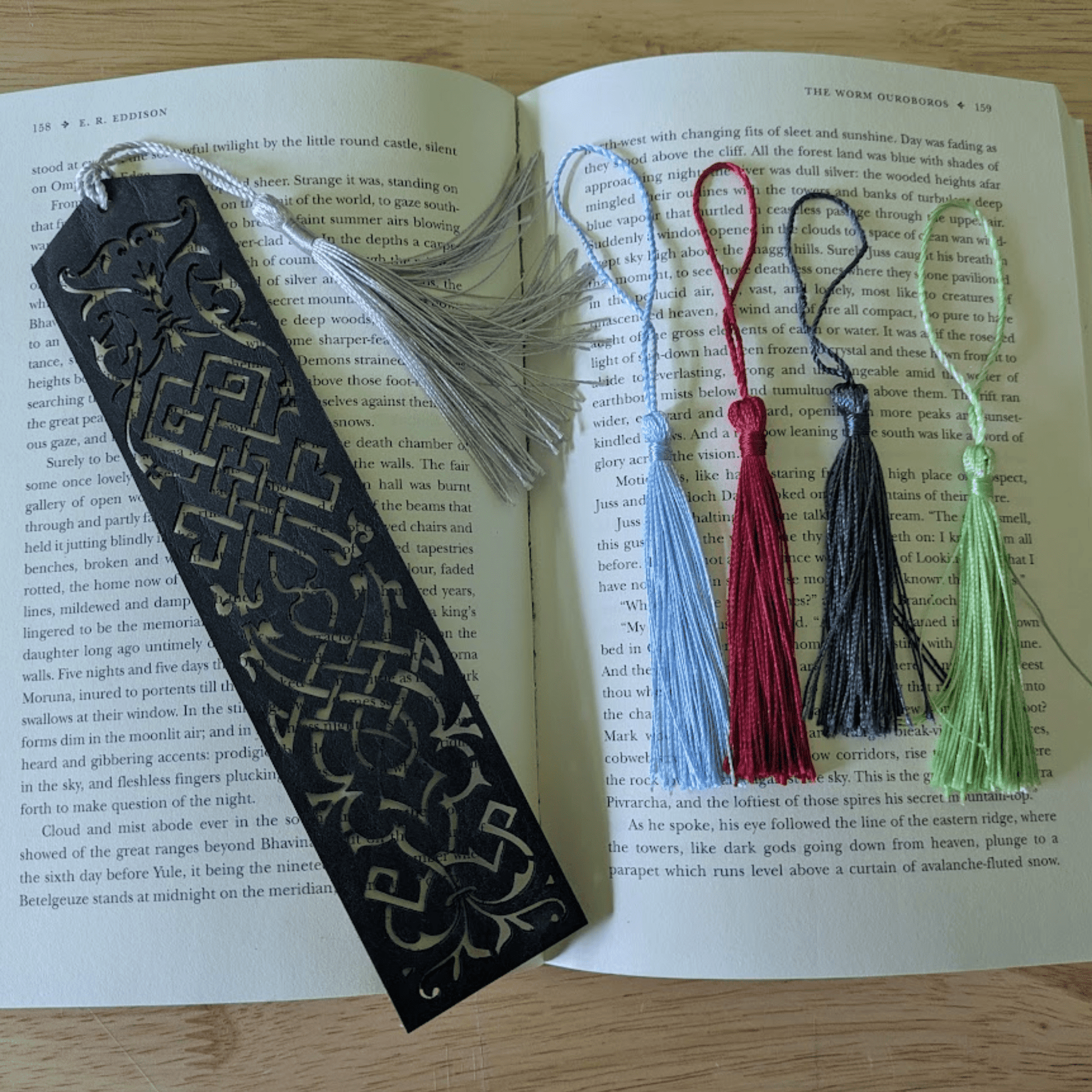 The dark leather bookmark next to the tassels you can pick from. Blue Cutout Leather Bookmark with Tassel Hole Bookmarks Raven King Crafts Elvish Style Leather Bookmarks - Pick your color and your tassel Bookmarks Raven King Crafts