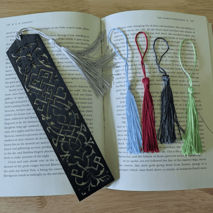 The dark leather bookmark next to the tassels you can pick from. Blue Cutout Leather Bookmark with Tassel Hole Bookmarks Raven King Crafts Elvish Style Leather Bookmarks - Pick your color and your tassel Bookmarks Raven King Crafts