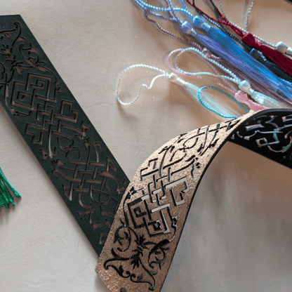 The backs of the leather bookmarks are unfinished but the scroll decal is cut through it. Elvish Style Leather Bookmarks - Pick your color and your tassel Bookmarks Raven King Crafts