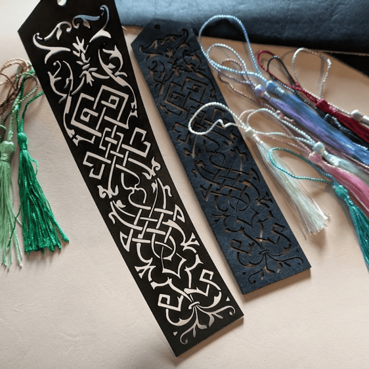 Green and blue leather bookmarks each with ornate cut outs and tassels Elvish Style Leather Bookmarks - Pick your color and your tassel Bookmarks Raven King Crafts