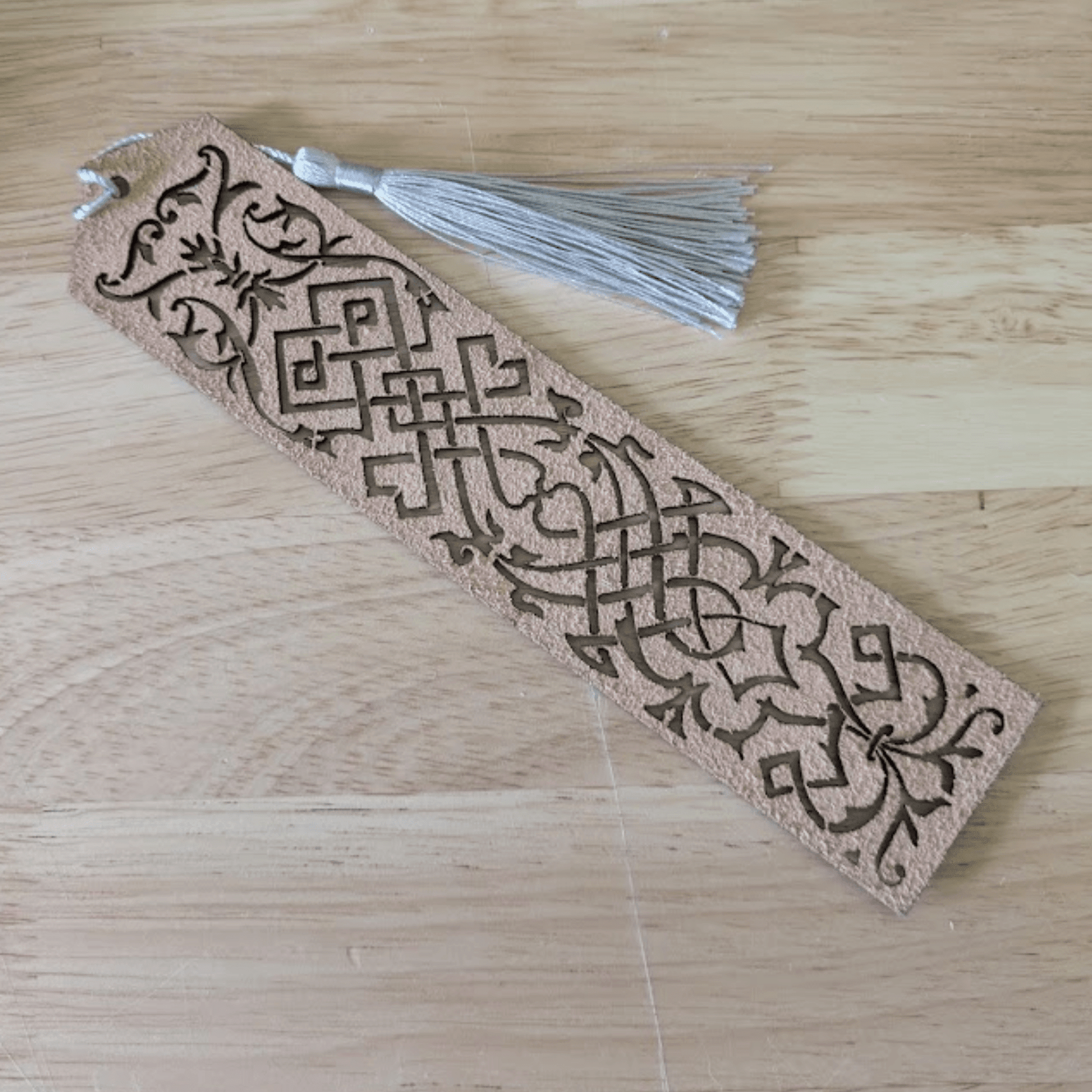 The back of the blue leather bookmark is unfinished. Blue Cutout Leather Bookmark with Tassel Hole Bookmarks Raven King Crafts Elvish Style Leather Bookmarks - Pick your color and your tassel Bookmarks Raven King Crafts