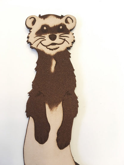 a ferret engraved on a leather bookmark