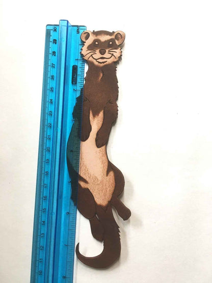 The leather weasel bookmark next to a ruler for scale. Ferret Bookmark Made From Hand Selected Leather Bookmarks Raven King Crafts