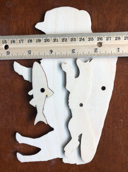 Another shot of the sanded North American woodlands creature cutouts next to a ruler for scale.